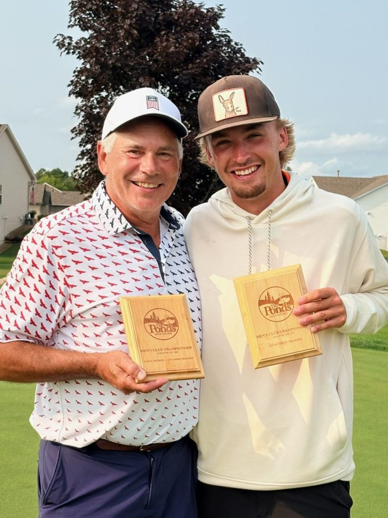 Golfers holding award