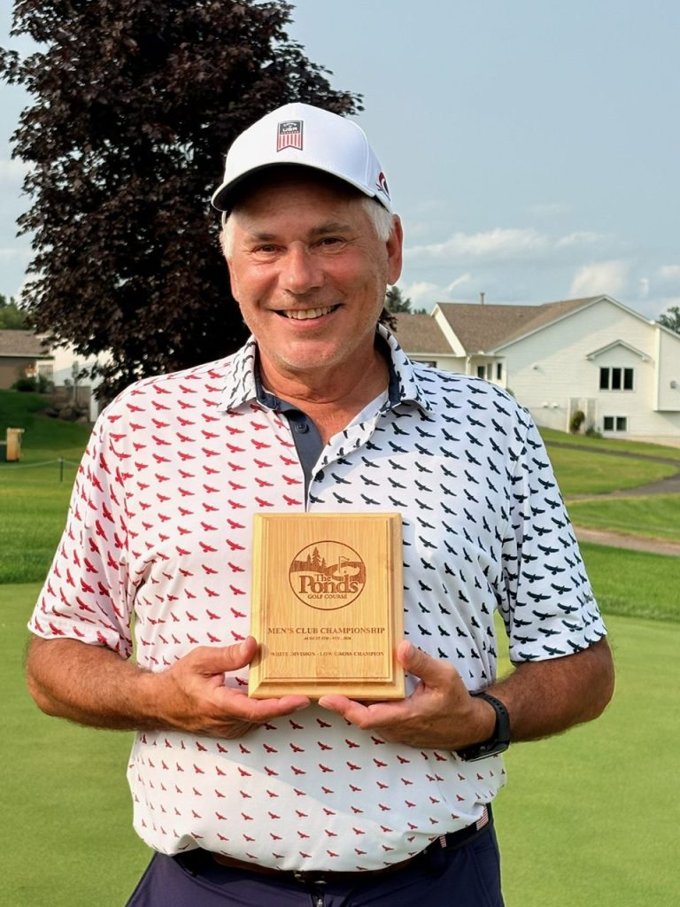 Golfer holding award