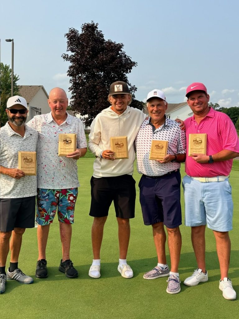 Golfers holding award